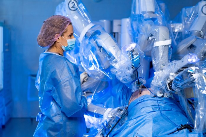 Doctor,Supervising,Robotic-assisted,Operation.,Surgeon,Observes,Robotic,Arms,Performing,Surgery